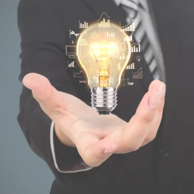 Image of a bulb floating above someones hand